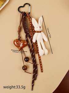 Detailed view of plush bunny and heart charm keychain with size and weight measurements