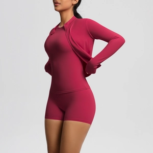 Detail of high-waisted shorts and zipper jacket in dark red seamless yoga set