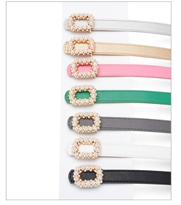 Detail view of thin women's belts with elegant square faux pearl-encrusted buckles in seven colors