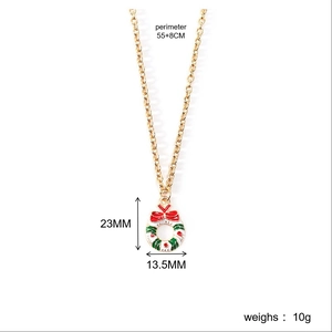 Detail showing red bow and enamel Christmas wreath pendant with measurement labels