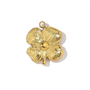 Detailed view of a textured gold-plated clover pendant with a top ring for DIY jewelry