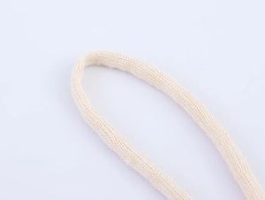 Macro close-up of cream knit ruffles showing detailed cotton fabric texture and weave