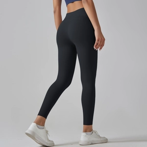 Detail of high-waisted black yoga leggings showing seamless hip lifting and elastic fabric
