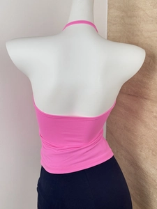 Detail of hot pink halter neck tank top featuring an open back design on a mannequin