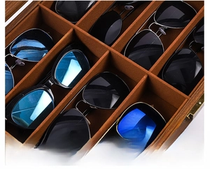 Macro view of multi-slot wooden glasses storage box with soft brown velvet lining