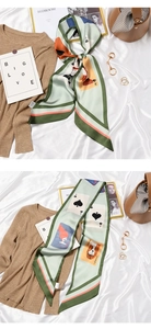 Detail of mint green rectangle scarf with poker card patterns on white silk backdrop