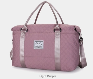 Close-up of quilted wavy stitching and woven brand label on purple travel duffel bag