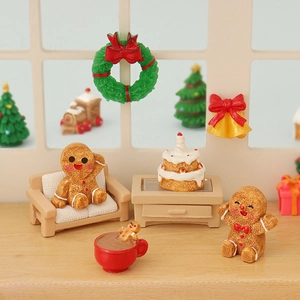 Miniature Christmas gingerbread scene with tiny furniture and festive holiday decorations