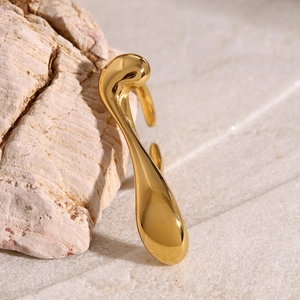Close-up of polished 18k gold stainless steel ring with unique water drop design