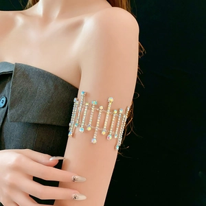 Detailed view of shimmering rhinestone tassel armlet with silver metal base on model