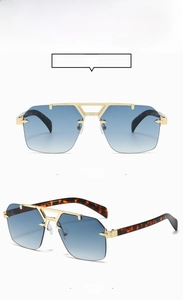 Detail of square rimless metal sunglasses with gold bridge and tortoiseshell temples