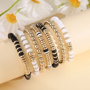 Detail of 6-piece bohemian beaded bracelet set featuring black and white heishi beads