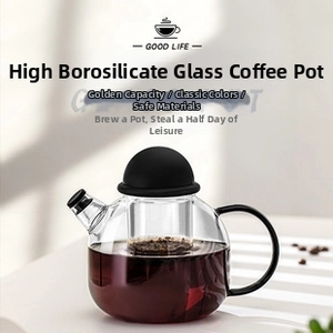 Detail of a heat-resistant glass coffee pot with black handle and spherical lid