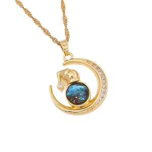 Luxury gold crescent moon necklace with blue celestial orb and sparkling crystal pavé