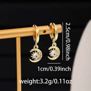 Detail showing gold moon and sun drop earrings with size measurements of 2.5cm by 1cm