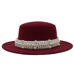 Detail of burgundy wool felt flat top hat featuring elegant multi-layer pearl decoration