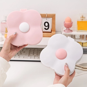 Pink and white flower-shaped cosmetic storage boxes with mirror for desktop organization