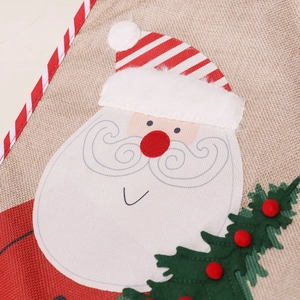 Christmas placemat featuring Santa Claus embroidery on rustic linen fabric texture