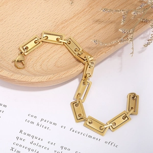 Minimalist gold stainless steel geometric link bracelet with lobster clasp on wooden tray