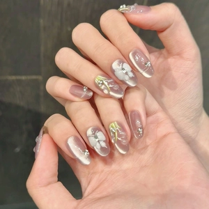 Pink cat eye press-on nails with 3D handmade flowers and pearl rhinestones