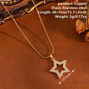 Elegant gold stainless steel star pendant necklace with cubic zirconia on a vintage backdrop