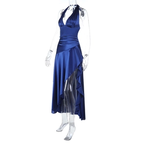 Detail of the high-slit hem and glossy satin fabric on this navy blue halter dress