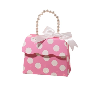 Pink polka dot paper gift bag with pearl handle and white silk bow for weddings