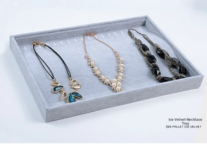 Gray ice velvet jewelry display tray showcasing rings necklaces and earrings