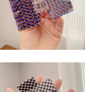 Detail of grid pattern hair claws in colorful and black-white checkered styles