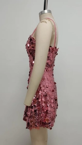Close-up side view of pink sequin mini dress featuring large round shimmering sequins