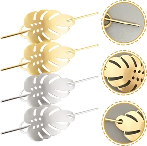 Set of 4 gold and silver metal monstera leaf hair pins with hollowed-out details