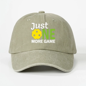 Detail of washed cotton baseball cap featuring Just One More Game pickleball print