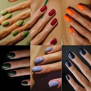 Glossy solid color press-on nails in green, red, orange, purple, and blue shades