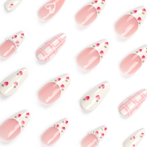 Sweet pink and white press-on nails with strawberry patterns and pearl accents