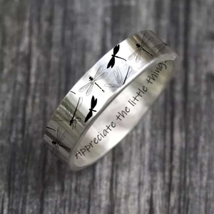 Detail of silver dragonfly ring with engraved text Appreciate the little things.