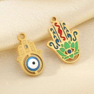 18K gold stainless steel Hamsa hand and evil eye charm pendants on gold silk
