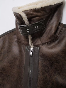 Detail of dark brown leather vest with soft teddy lining and metal buckle neck strap
