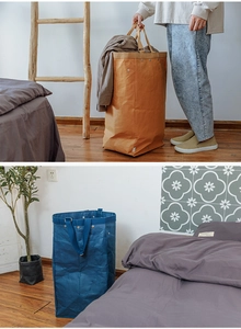 Detail of washable kraft paper storage bags in brown and blue with durable handles
