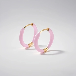 Close-up of pink enamel hoop earrings with gold finish and snap closure detail