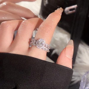 Macro view of a silver double-layered halo ring with oval zircon and pearl accents