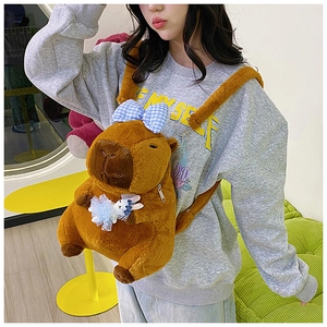 Detail view of brown plush Capybara backpack featuring a cute blue checkered bow and bunny