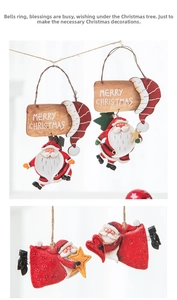 Detail of resin Santa Claus hanging ornaments with Merry Christmas signs and stars