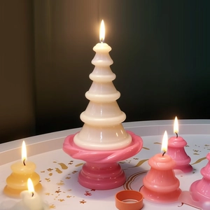 Christmas tree scented candle set with pink base and burning candles for home decor