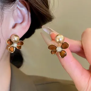 Elegant 18k gold plated flower stud earrings with champagne pearl and amber resin petals