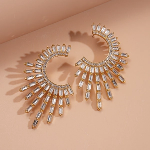 Detailed view of luxury gold C-shape floral earrings with sparkling rectangular crystals