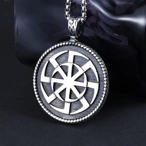 Macro shot of silver Viking Kolovrat pendant on square pearl chain in stainless steel
