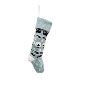 Detail of light blue knitted pet Christmas stocking with paw and snowflake patterns