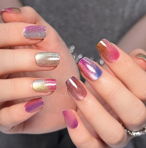 Close-up of rainbow cat-eye press-on nails with sparkling gradient and high-gloss finish
