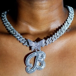 Close-up of hip-hop silver butterfly and letter B iced-out pendant on Cuban chain