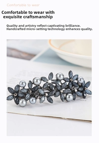 Close-up of floral hair clip with grey pearls, glitter petals and delicate rhinestones